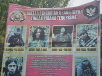 Posters of photos of members of the East Indonesian Mujahidin terrorist group are plastered at the entrance to Lembantongoa Village, Palolo...