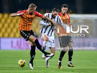 Adrien Rabiot of Juventus FC is challenged by Artur Ionita of Benevento and Kamil Glik of Benevento Calcio during the Serie A match between...