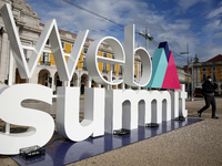 A man wearing a face mask walks past a 3D logo of Web Summit in downtown Lisbon, Portugal on November 30, 2020. Web Summit, Europe’s biggest...