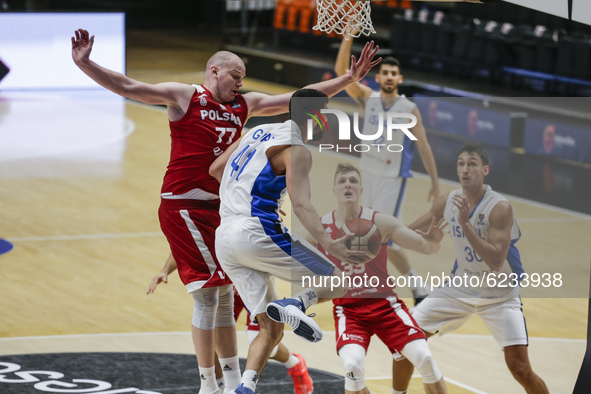 41 Tomer Ginat of Israel defended by 77 Damian Kulig of Poland during the FIBA EuroBasket 2022 Qualifiers match of group A between Israel an...