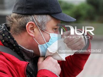 A man wearing two protective face masks amid the COVID-19 coronavirus epidemic walks in the center of Kyiv, Ukraine on 30 November 2020. (