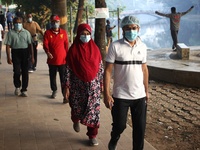 Health-conscious people wear mask as they exercise at Dhanmondi Lake area amid Covid-19 pandemic in Dhaka, Bangladesh on Tuesday, December 0...