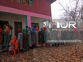 Women voters in queue to cast their votes during the second phase of District Development Council (DDC) election in Lalpora area of north Ka...