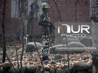 A paramilitary soldier guards the polling station during the second phase of District Development Council (DDC) election in north Kashmir on...