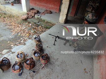 Kangris (Fire-pots which keeps people warm) are kept outside the polling station by the voters during the second phase of District Developme...