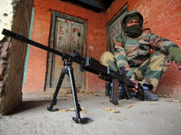 A paramilitary soldier guards the polling station during the second phase of District Development Council (DDC) election in north Kashmir on...