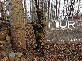 An Indian military soldier guards the polling station during the second phase of District Development Council (DDC) election in north Kashmi...