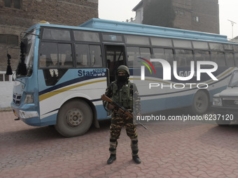 Indian forces stand alert outside a voting booth duirng second phase of DDC, ULP elections in Srinagar, Indian Administered Kashmir on 01 De...