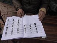 Voting officials check the voting list outside a voting booth duirng second phase of DDC, ULP elections in Srinagar, Indian Administered Kas...