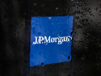 JP Morgan logo displayed on a phone screen is seen through raindrops on the window in this illustration photo taken in Poland on November 30...