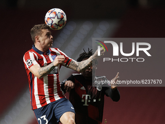 Kieran Trippier of Atletico Madrid and Arrey-Mbi of Bayern  compete for the ball during the UEFA Champions League Group A stage match betwee...