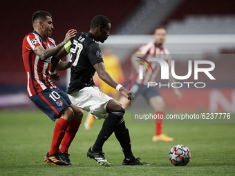 David Alaba of Bayern and Angel Correa of Atletico Madrid compete for the ball during the UEFA Champions League Group A stage match between...