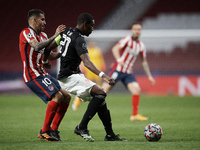 David Alaba of Bayern and Angel Correa of Atletico Madrid compete for the ball during the UEFA Champions League Group A stage match between...