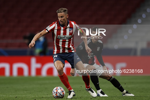 Marcos Llorente of Atletico Madrid and Lucas Hernandez of Bayern compete for the ball during the UEFA Champions League Group A stage match b...
