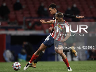 Marcos Llorente of Atletico Madrid and Jamal Musiala of Bayern compete for the ball during the UEFA Champions League Group A stage match bet...
