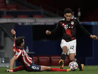 Jamal Musiala of Bayern and Saul Niguez of Atletico Madrid compete for the ball during the UEFA Champions League Group A stage match between...