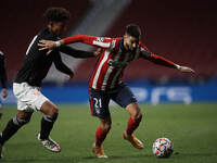 Chris Richards of Bayern and Yannick Carrasco of Atletico Madrid compete for the ball during the UEFA Champions League Group A stage match b...