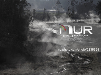 The smoke are seen on Besuk Kobokan river which full of volcanic materials fom the eruption of mount Semeru (3.676 masl) in Sumbersari villa...