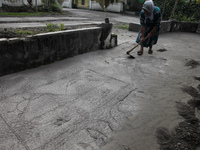 Villagers of Sumbersari clean the their house yard from volcanic ash due to the eruption of mount Semeru (3.676 masl) in Sumbersari village,...