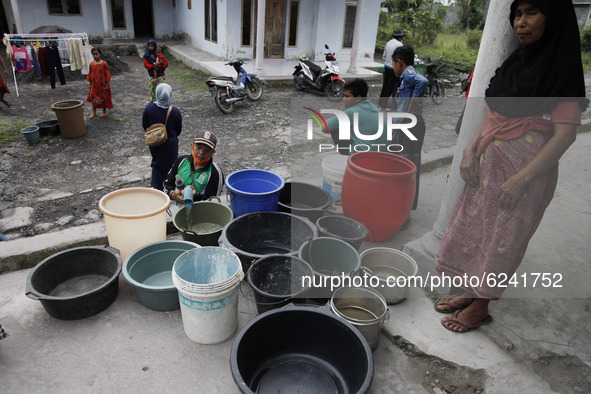 Villagers of Sumbersari receive a clean water assistance from the Indonesian National Disaster Management Agency, Lumajang subdistrict, East...