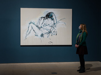 (EDITORIAL USE ONLY) A gallery staff member looks at ‘You were here like the ground underneath my feet’ (2016) during a photocall for the Tr...