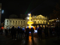 Tourists photograph the Albero del Vento in Piazza della Scala in Milan during coronavirus emergency, Milan, Italy, on December 07 2020. The...