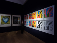 (EDITORIAL USE ONLY) A staff member looks at Robert Indiana's (1928-2018) The Book of Love, 1996 (est. £60,000 - 80,000) during a photo call...