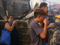 After a 3rd alarm fire hits residential area in Ilaya, Alabang, Philippines in 12 midnight of Friday. Residents back to their houses on Dece...