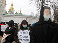 Protestors stand next to an effigy depicting the Ecumenical Patriarch of Constantinople Bartholomew I  during their rally in Kyiv, Ukraine o...