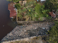 Aerial photo shows  floating plastic and styrofoam trash polluting a corner of Siak River , Pekanbaru. . The accumulation of garbage occurs...