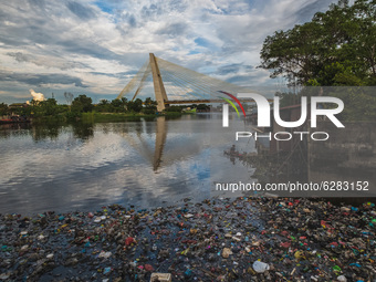 A man rows a boat on the Siak river which is covered by plast waste in Pekanbaru., Riau Province, Indonesia, Dec 17, 2020.
The accumulation...