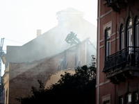 Smoke rises from a destroyed building that collapsed and caught fire after an explosion in Lisbon downtown, Portugal, on December 20, 2020....