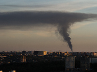A dark cloud of smoke is seen over city scape as fuel storage terminal burns near Kyiv, June 8, 2015. (