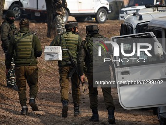 Indian security forces move towards the gun-battle site in Wanigam Payeen village of north Kashmir's Baramulla district on December 24, 2020...