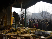 Kashmiri people assess the damaged residential house in Kanigam Village of Shopian district, South of Srinagar, Indian Administered Kashmir...