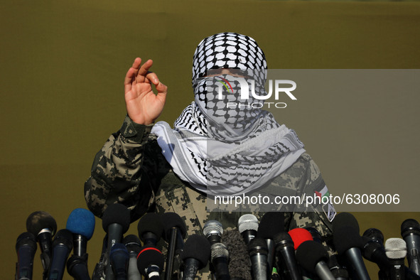 A Palestinian militant gestures as he speaks to the media during the first-ever joint exercise by Palestinian militant groups, in Gaza City...