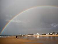 The rainbow is seen during a traditional sea bath to welcome the new year at Carcavelos beach on the outskirts of Lisbon, Portugal on Januar...