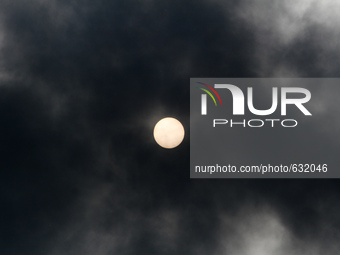 The Sun is seen through the dark cloud of smoke rising over burning fuel storage terminal near Kyiv, June 9, 2015. (