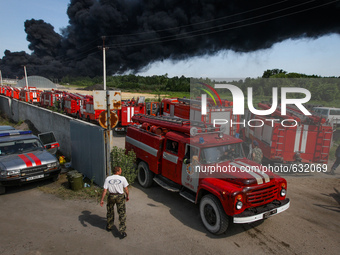 Hundreds of Ukrainian firefighters battled Tuesday to keep a blaze sparked by a deadly string of fuel depot blasts from engulfing a strategi...