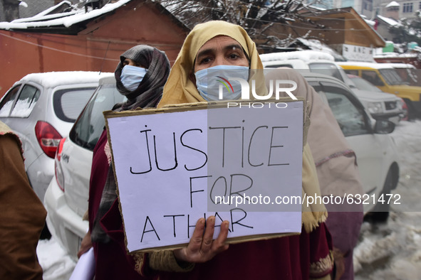 Relative of killed alledged militant holds a placard during protest in Srinagar, Indian Administered Kashmir on 04 January 2021. Families of...