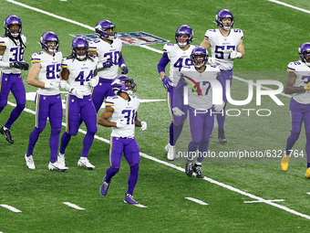 Minnesota Vikings players walk onto the field before a play during the first half of an NFL football game between the Detroit Lions and the...