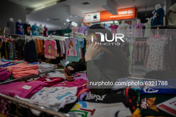 A clothes seller waiting for customer in Jakarta, Indonesia, on January, 4, 2021. Situation at A Mall in Jakarta that impacted by Covid19 Pa...