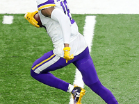 Minnesota Vikings wide receiver Justin Jefferson (18) carries the ball during the second half of an NFL football game between the Detroit Li...