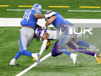 Minnesota Vikings wide receiver Justin Jefferson (18) is taken down by Detroit Lions defensive end Austin Bryant (94) and Detroit Lions outs...
