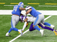Minnesota Vikings wide receiver Justin Jefferson (18) is taken down by Detroit Lions defensive end Austin Bryant (94) and Detroit Lions outs...