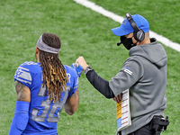 Detroit Lions head coach Darrell Bevell fist bumps Detroit Lions cornerback Mike Ford (38) on the sidelines during the second half of an NFL...