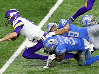 Minnesota Vikings quarterback Kirk Cousins (8) is tackled by Detroit Lions defensive end Julian Okwara (99) and Detroit Lions strong safety...
