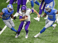 Minnesota Vikings quarterback Kirk Cousins (8) is pursued by Detroit Lions defensive end Julian Okwara (99) and Detroit Lions strong safety...