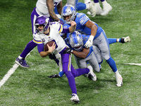 Minnesota Vikings quarterback Kirk Cousins (8) is pursued by Detroit Lions defensive end Julian Okwara (99), Detroit Lions linebacker Jalen...