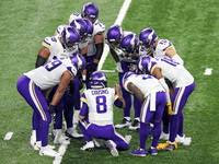 Minnesota Vikings quarterback Kirk Cousins (8) talks with teammates in the huddle during the second half of an NFL football game between the...